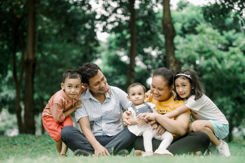Family relaxing together outdoors in Kitchener